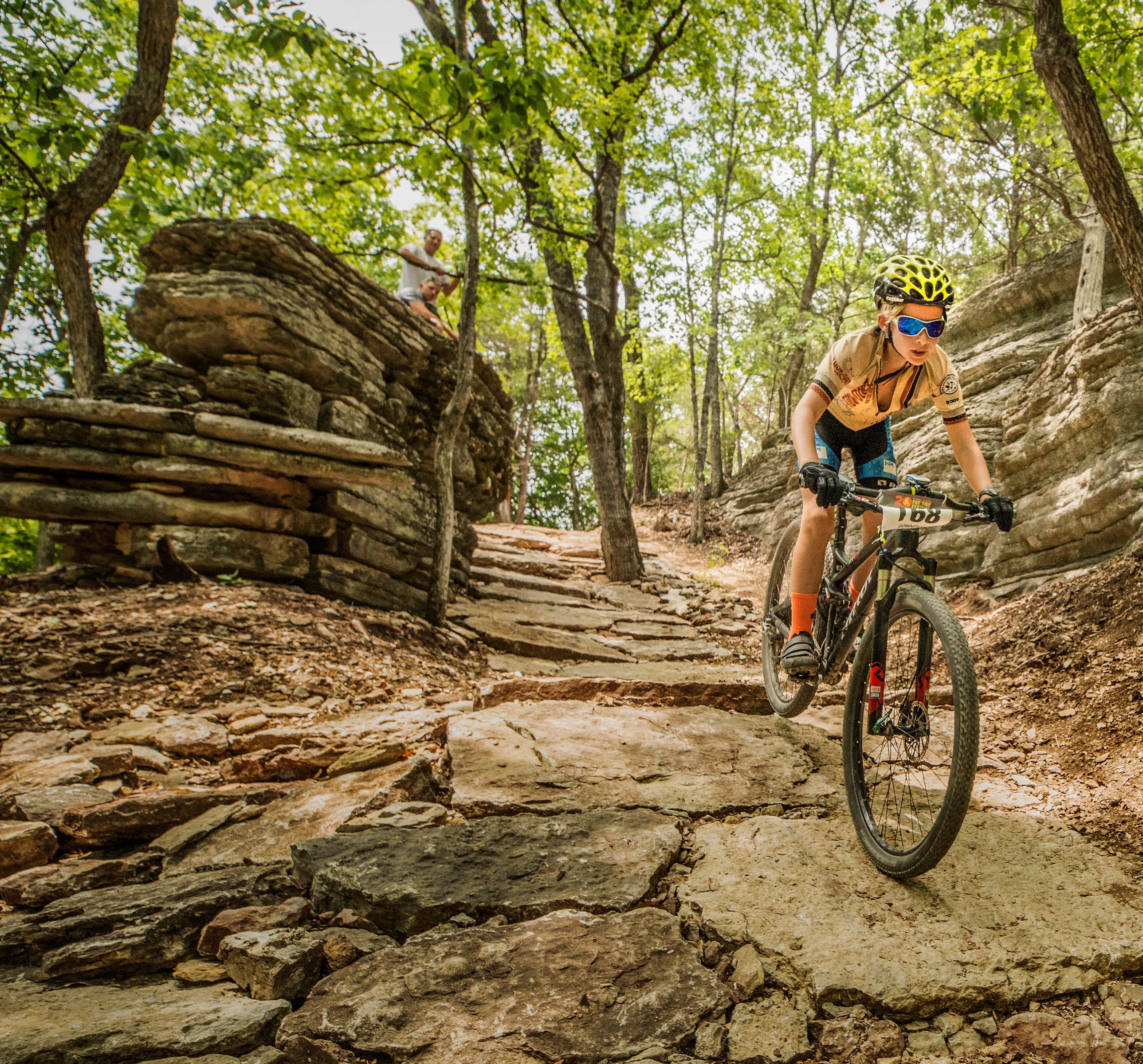 woman riding down a mountain bike trail